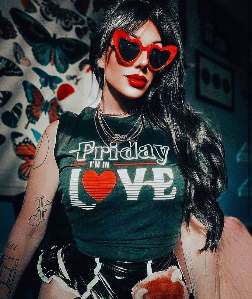 A woman wearing the Friday I'm In Love tee