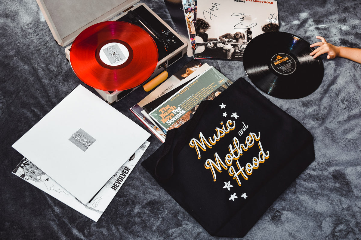 Records, a record player with red vinyl and a Music and Motherhood tote